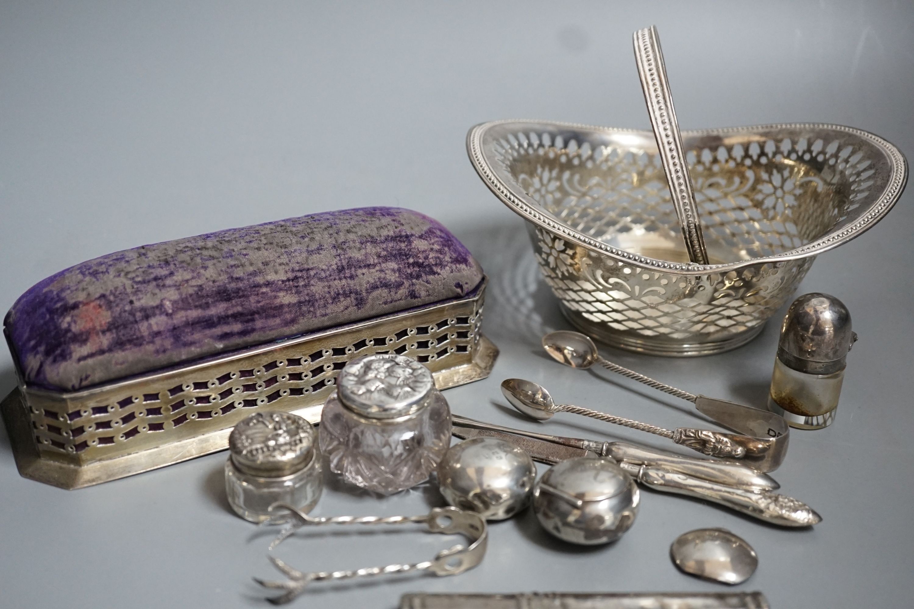 Small silver including two pill boxes, a silver mounted pin cushion, a sterling bonbon basket, etc.